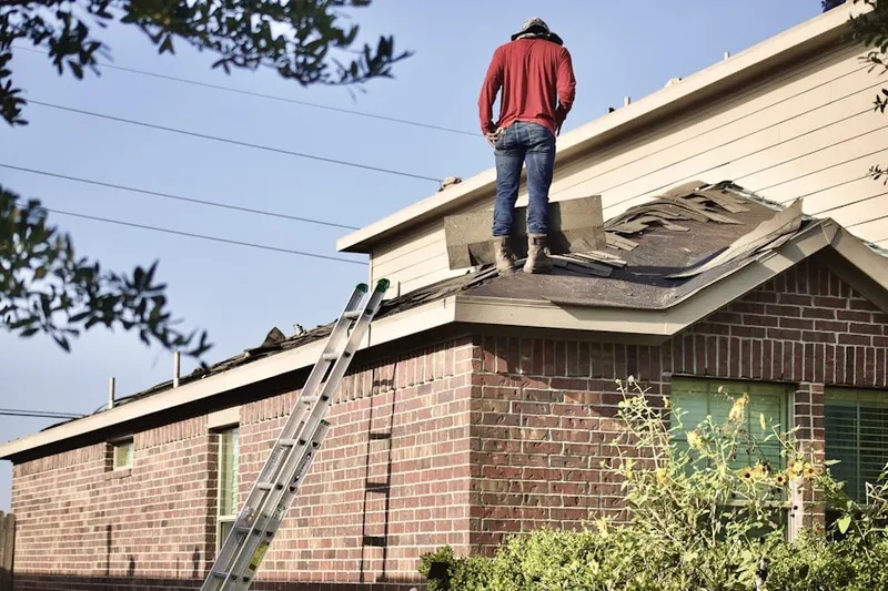 Professional roofer working on a residential roof in Barnard